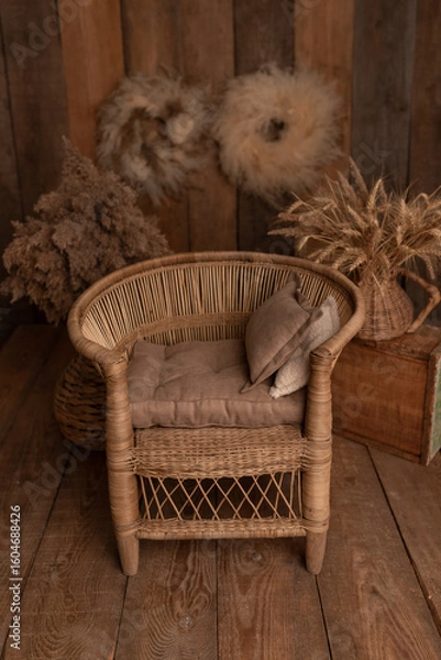 Obraz Boho style. Retro wicker chair for photo shoot. Chair for child. Children's photo zone. Brown photo zone.