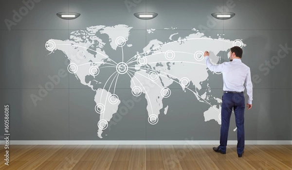 Fototapeta Businessman using digital planet earth interface on a wall 3D rendering