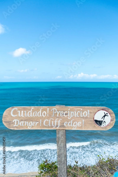 Fototapeta Warning sign on cliff edge viewpoint at Pipa ecological reserve Brazil