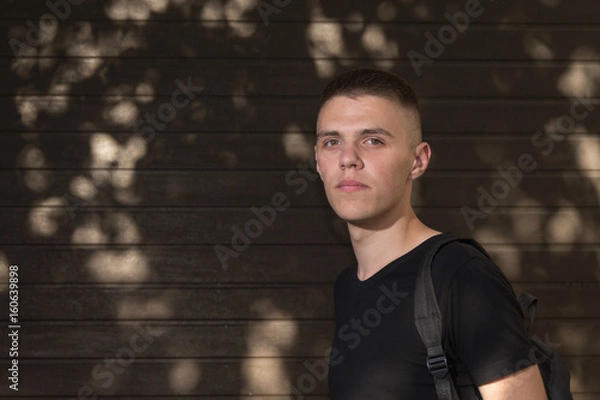 Obraz Teenage Boy looking at camera on background of Urban wall