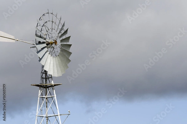 Obraz Windmill with a cloudy sky brackground