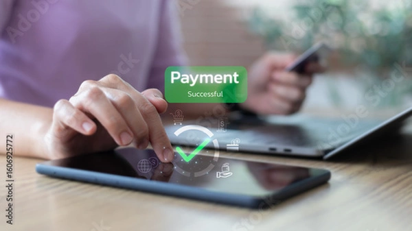 Obraz Hand touching tablet with payment successful message and financial icons, representing digital transaction, mobile payment, and online wallet system.
