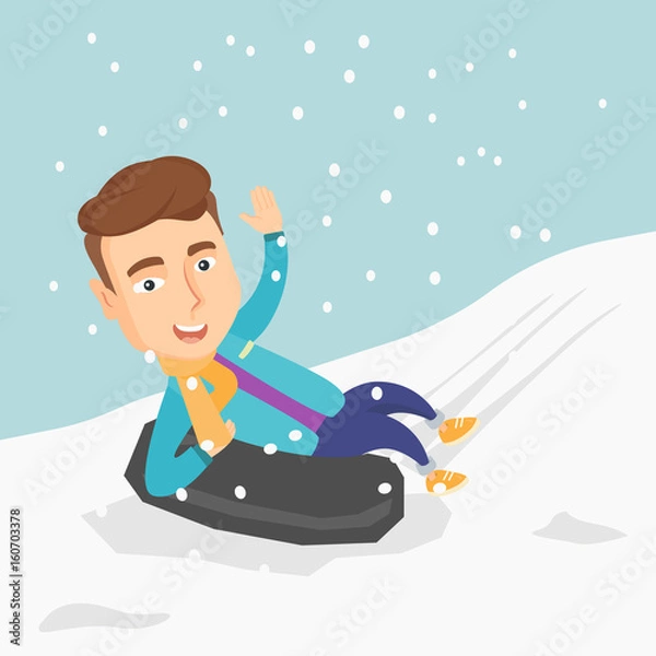 Fototapeta Man sledding on snow rubber tube in the mountains.