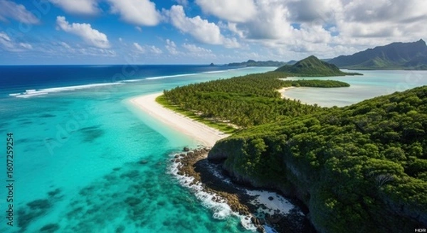 Fototapeta Exotic tropical island paradise with turquoise waters lush green vegetation and white sandy beach under a blue sky with fluffy clouds