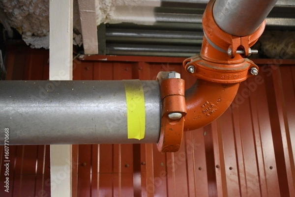 Obraz Large fire suppressor pipe under stadium grand stands.