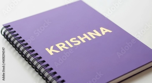 Fototapeta Purple Spiral Notebook with Golden Krishna Embossed on the Cover