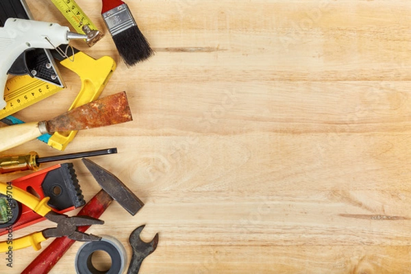Fototapeta Hand tools on wooden background with copy space, Top view