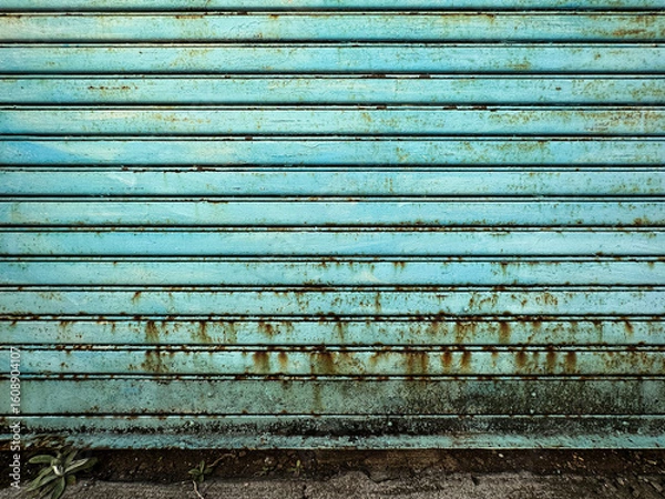 Obraz 錆びがでている汚れた古い水色のシャッター