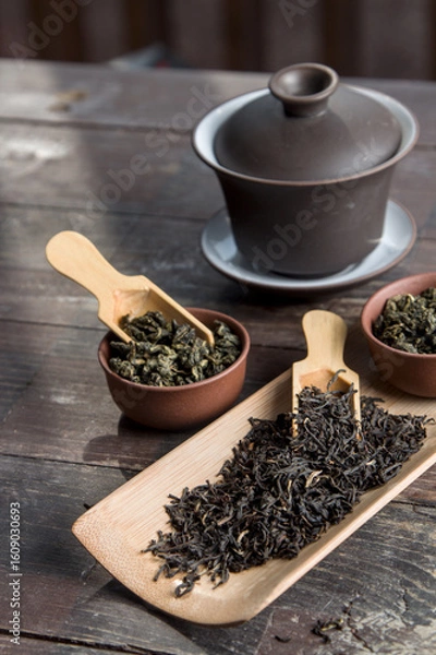 Fototapeta Chinese tea, making tea in a traditional,  in a small cups and teapot over dark background