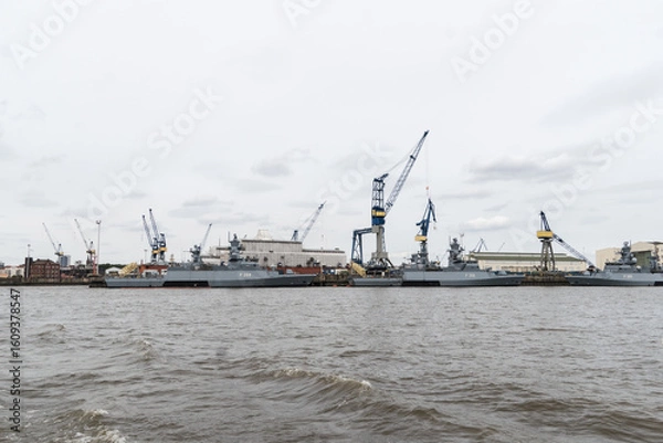 Fototapeta Port with cranes and war ships in Hamburg Germany