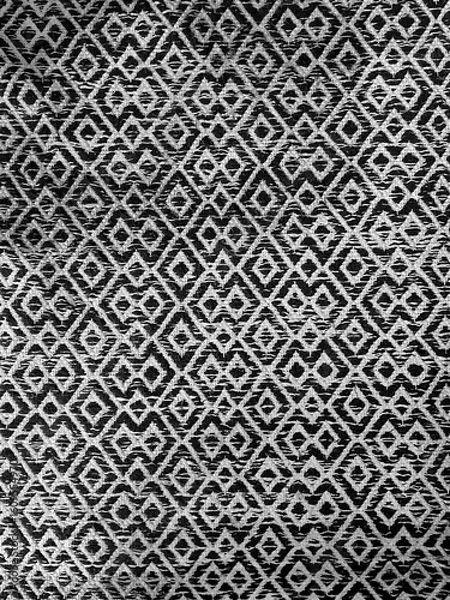 Fototapeta Black and white geometric fabric texture with diamond shapes in a seamless pattern. Perfect for backgrounds, textile design, wallpapers, and modern decorative concepts.