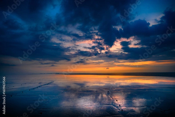 Fototapeta A view of the sea with blue skies and dynamic clouds