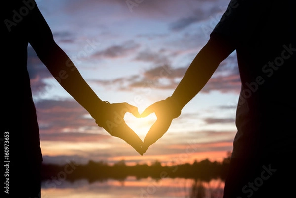 Obraz hands forming a heart shape with sunset silhouette