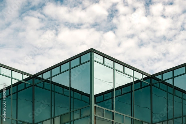 Fototapeta Clouds and reflections on a glass building