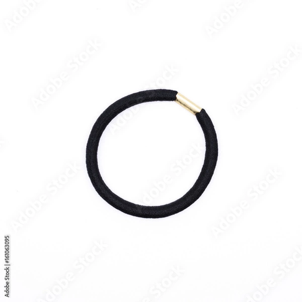 Fototapeta Closeup of a simple black hair band isolated on white background.