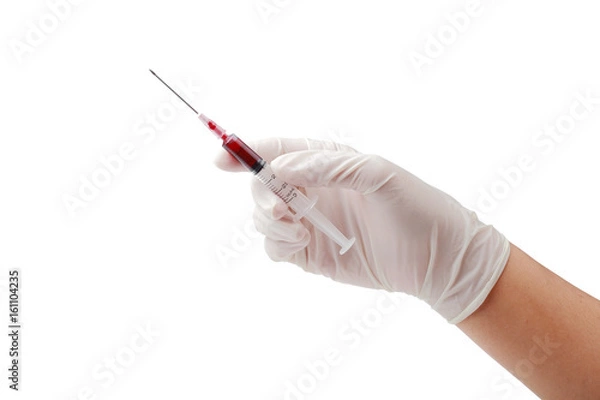 Obraz Hand holding disposable syringe loaded for injection isolated clipping path.