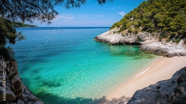 Fototapeta Secluded cove with turquoise water and lush greenery on a sunny day