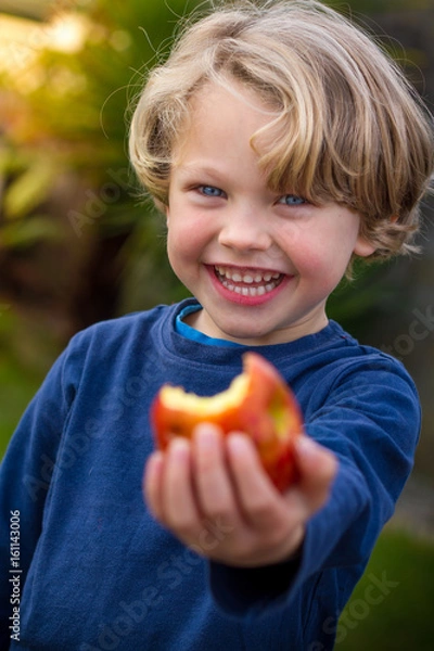 Obraz cute 5 year old child eating an apple