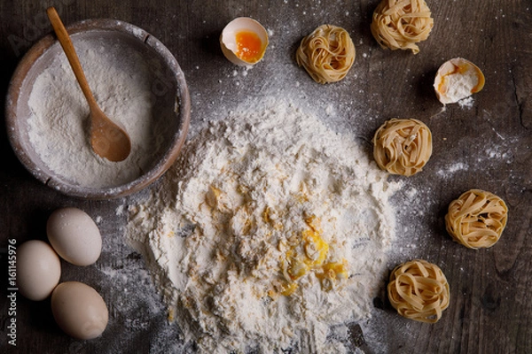 Fototapeta Ingredients for baking on a wooden background.
