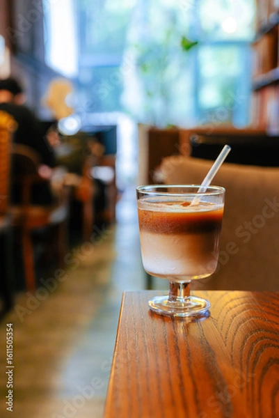 Fototapeta Iced Latte Moment in a Cozy Book Cafe