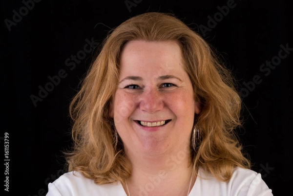 Fototapeta Portrait of a attractive european light overweighted red haired female in white shirt, headshot in front of black backgrouind