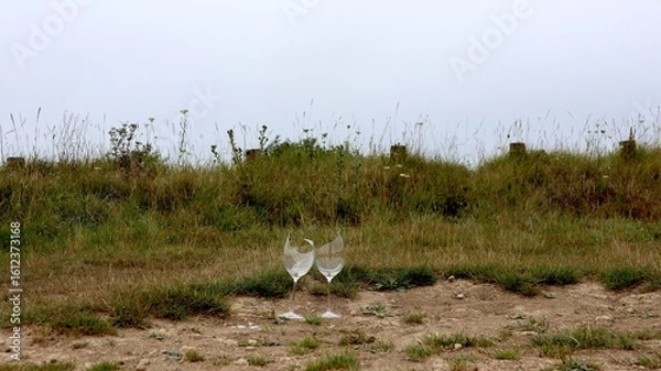 Obraz Wild party night – two broken champagne glasses Wine glasses in front of the dunes on the beach in Normandy, France.