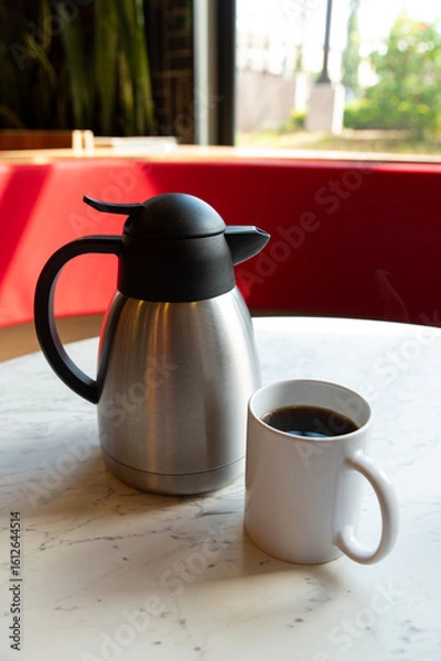 Obraz Coffee, Orange Juice and Thermos on Marble Table in Café Setting