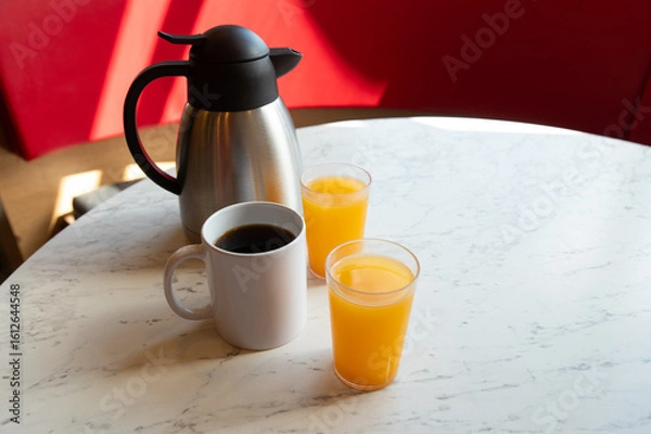 Obraz Coffee, Orange Juice and Thermos on Marble Table in Café Setting