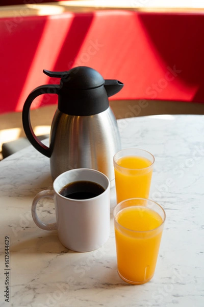 Obraz Coffee, Orange Juice and Thermos on Marble Table in Café Setting
