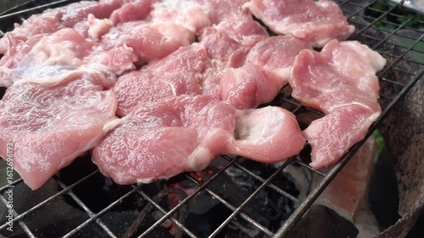 Fototapeta Pork grilled on a charcoal grill