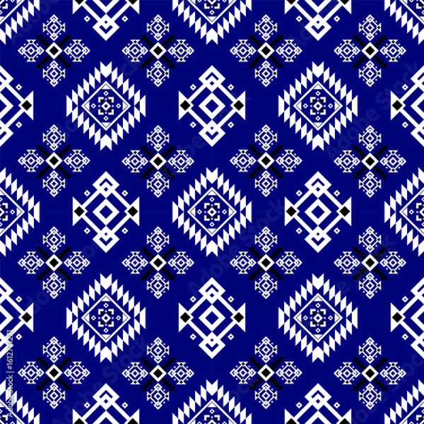 Fototapeta Blue and white geometric tribal pattern featuring diamond shapes and intricate symmetrical motifs in a repeating design.