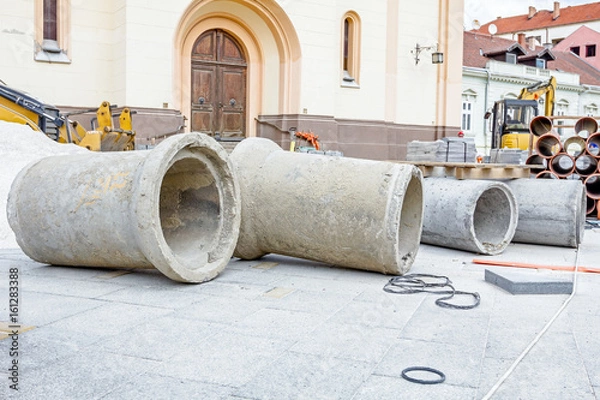 Fototapeta Concrete drainage pipes are on a construction site ready to be placed in