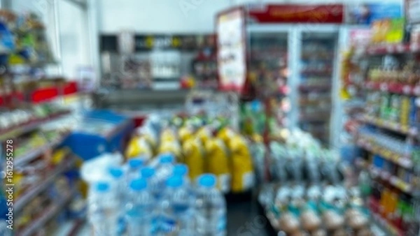 Fototapeta Abstract defocused background of a minimarket or convenience store. Blurred minimarket shop
