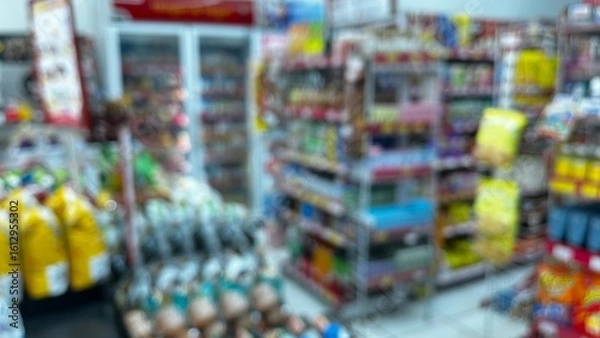 Fototapeta Abstract defocused background of a minimarket or convenience store. Blurred minimarket shop