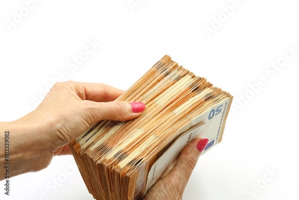 Obraz Woman's hand holding a bundle of 50 euro bills. Space for text.