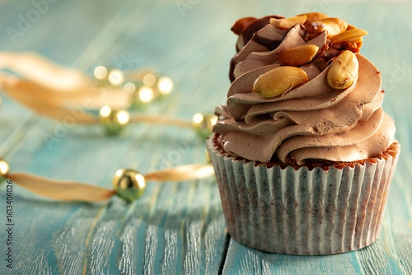 Obraz cupacke with on blue wooden table