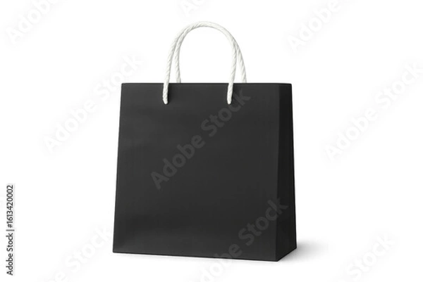 Fototapeta Black shopping bag featuring white rope handles, photographed in studio setting against transparent background, symbolizing retail consumer culture