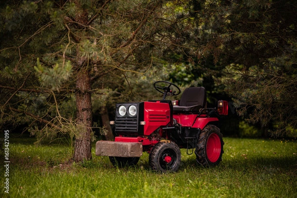 Fototapeta old red tractor in a field