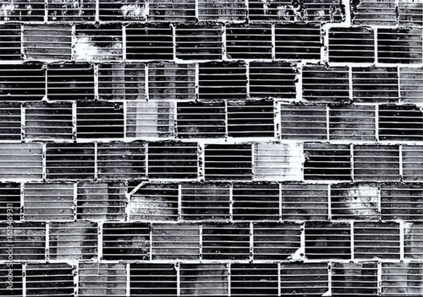 Fototapeta Abstract and detailed close-up of a brick wall , rendered in striking black and white tones. The monochromatic palette emphasizes the rough texture, geometric patterns.