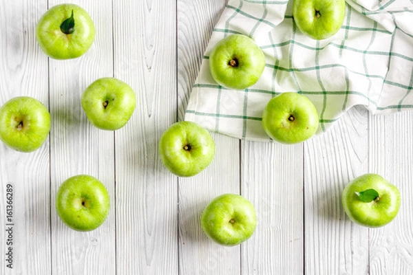 Obraz fitness food with green apples and napkin on white background top view