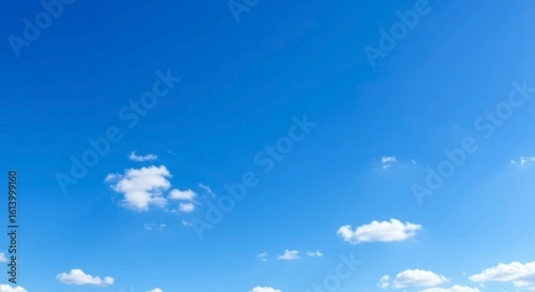 Fototapeta Clear blue sky with scattered clouds