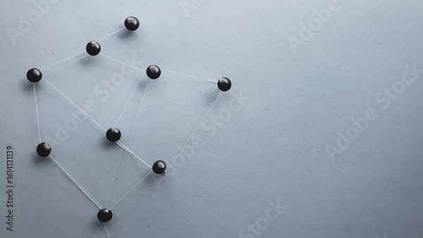 Fototapeta metal tacks attached with thread to a sheet representing a communication network and a dark background
