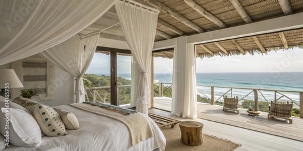 Obraz A bright bedroom with a canopy bed and ocean view from the balcony with wooden chairs and a thatched roof