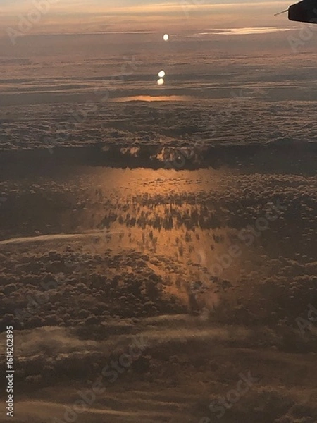 Obraz Sunset over the clouds from a plane 