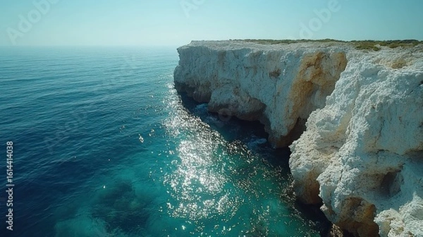 Fototapeta Coastal Cliffside, Turquoise Waters Gleaming in Sunlight