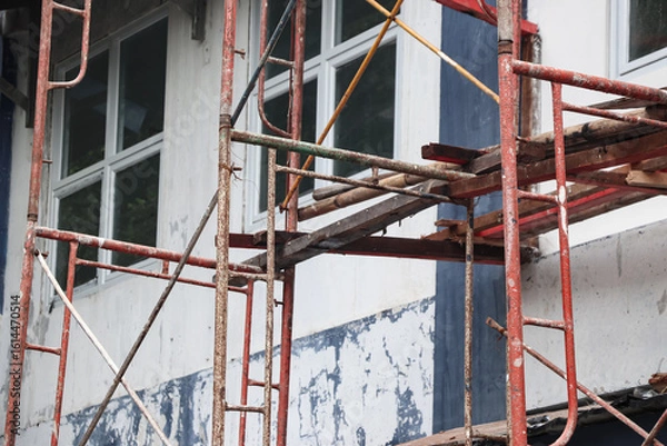 Obraz Several scaffolds installed in front of a building were photographed close up, some wood and bamboo were installed between the scaffolds which were useful as footholds for the construction workers