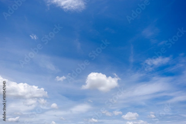 Fototapeta clear blue sky background,clouds with background, Blue sky background with tiny clouds. White fluffy clouds in the blue sky. 
Captivating stock photo featuring the mesmerizing beauty of the sky and cl