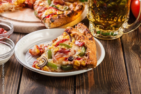 Fototapeta Slices of pizza with bacon, paprika and corn