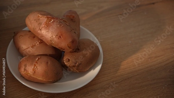 Fototapeta Close-up of boiled unpeeled potatoes stacked on plate