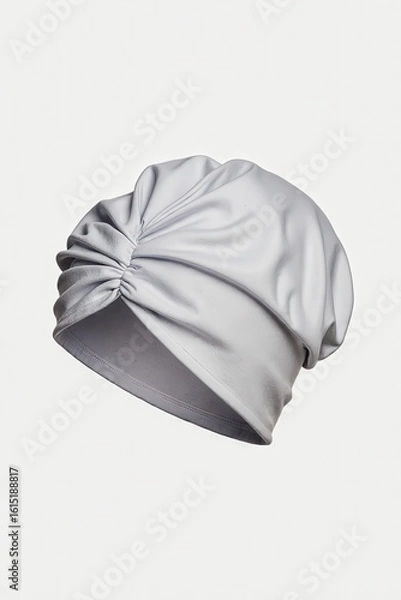 Fototapeta Elegance Unveiled: A minimalist studio shot of a stylish turban, its graceful folds and soft fabric evoking a sense of refined fashion.